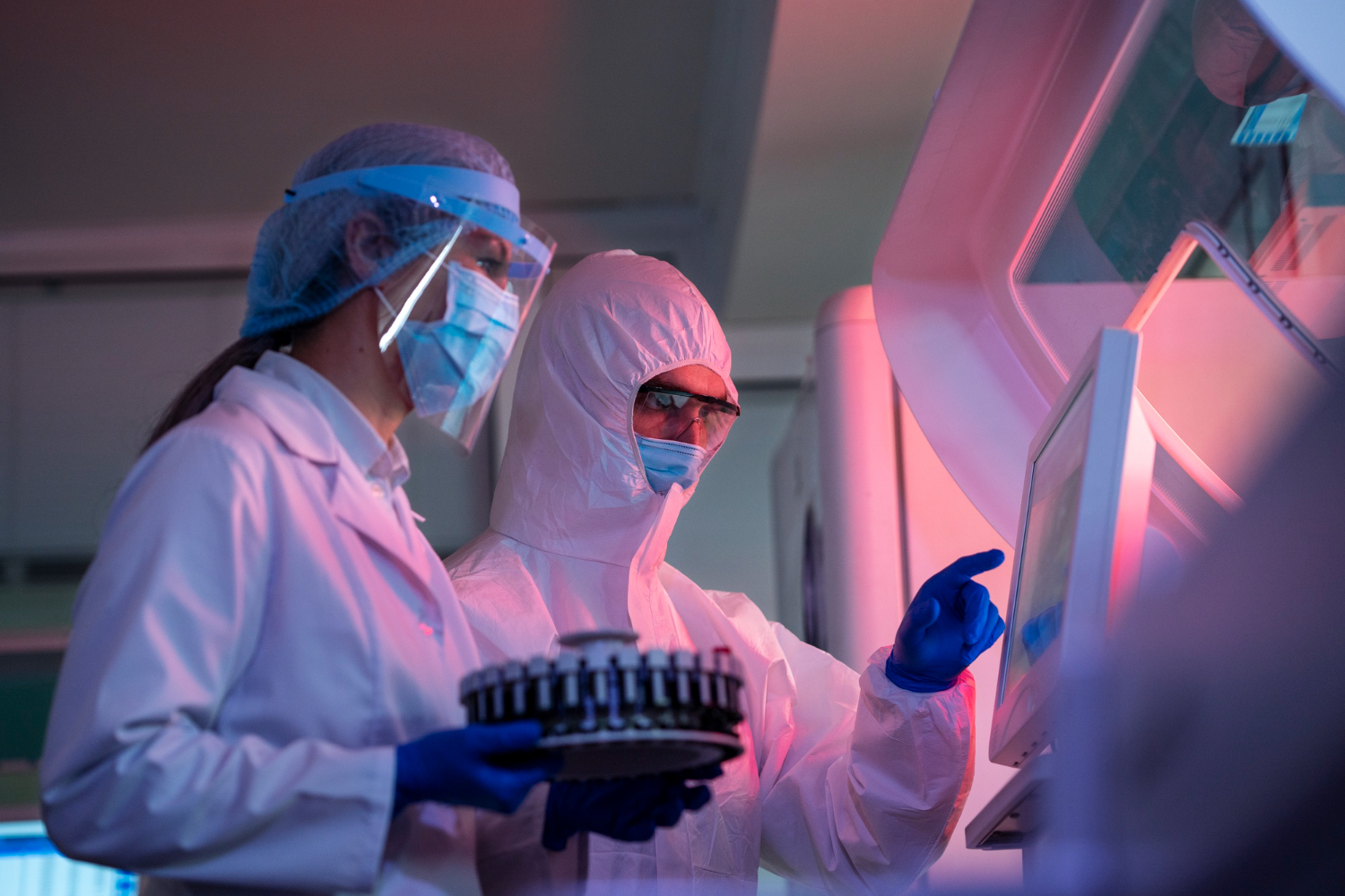 Biotech professionals in lab gear conducting safety compliance training