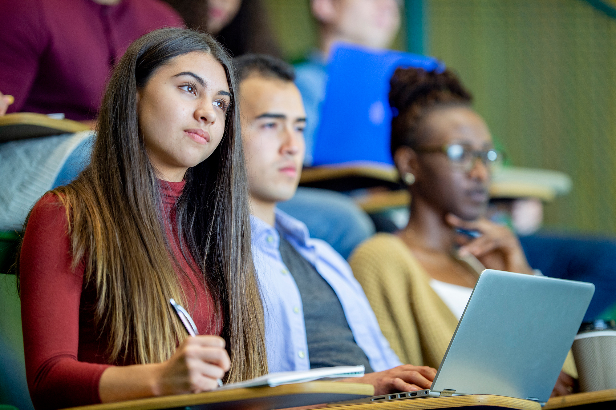 College students attentively listening during campus safety training lecture