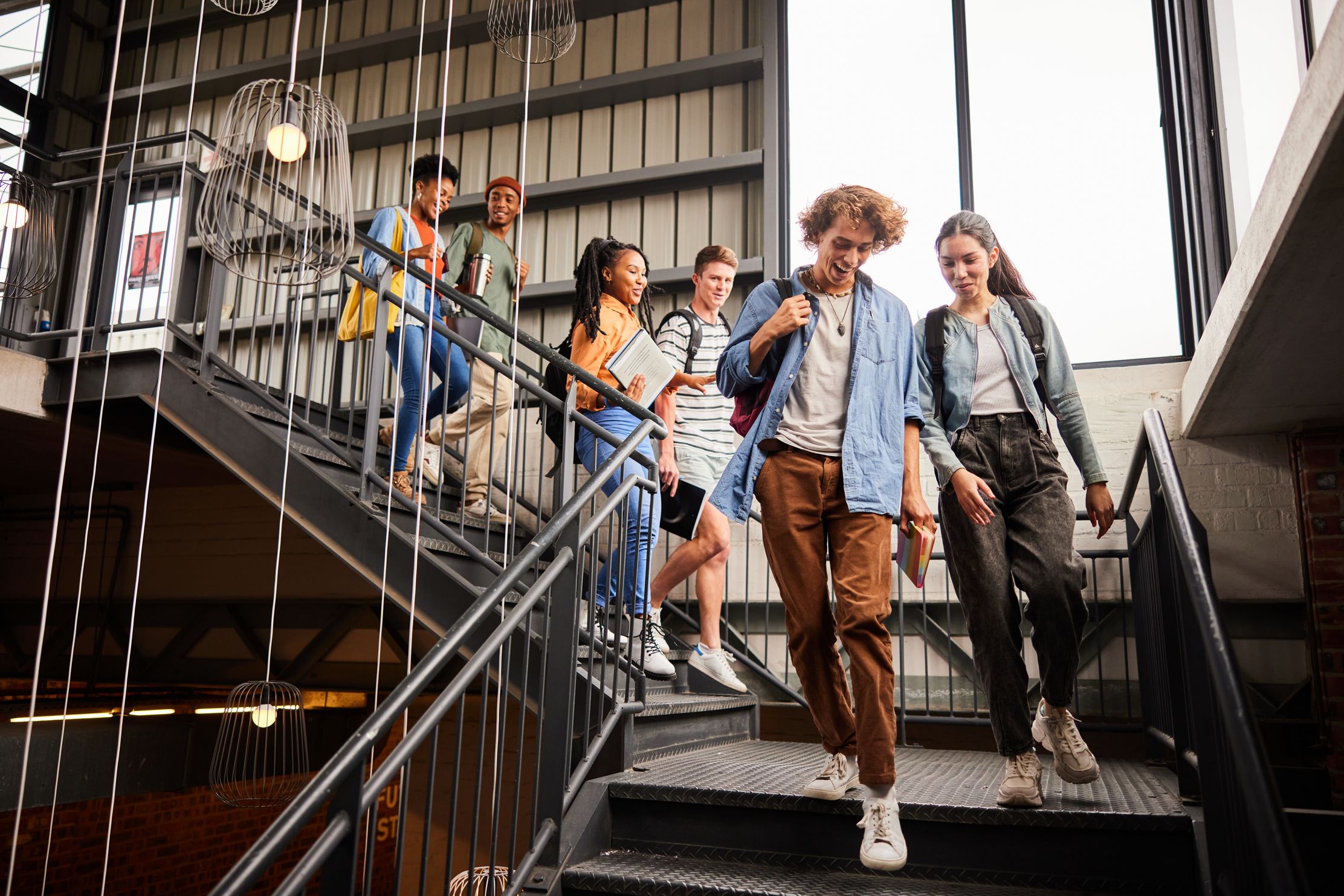 Group of college students walking down stairs on campus during safety training