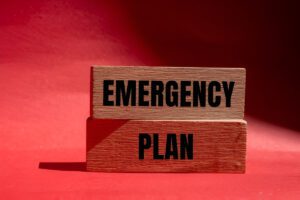 Emergency planning checklist and supplies on table for disaster preparedness