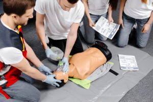 Instructor demonstrating CPR on a training manikin during a certification class