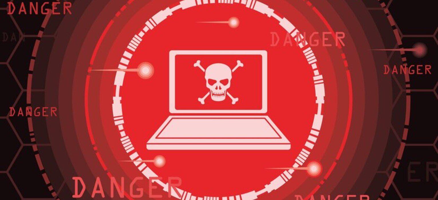 Laptop with skull and crossbones symbolizing malware threat, surrounded by "DANGER" text, highlighting cybersecurity risks in malware basics training.