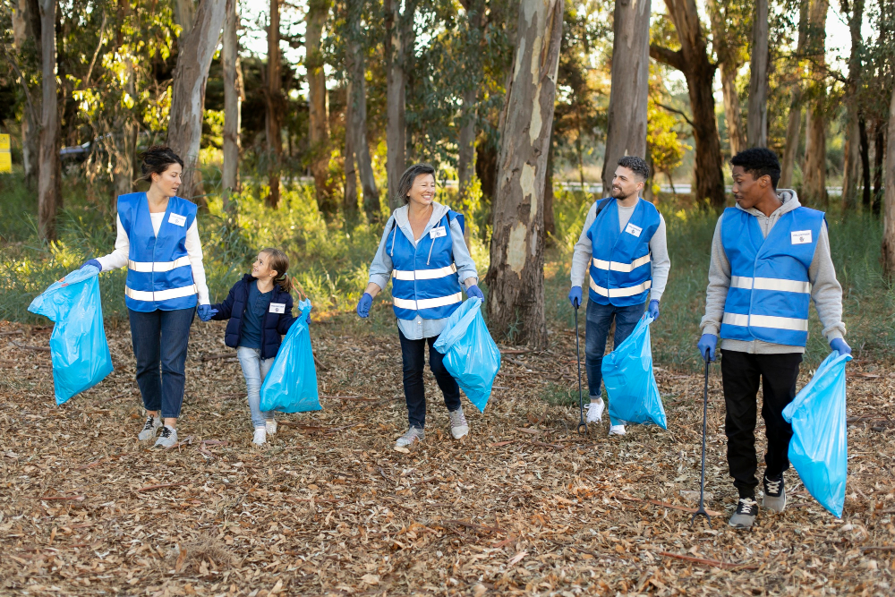 Municipality volunteers collecting trash in park during safety and cleanup program.”